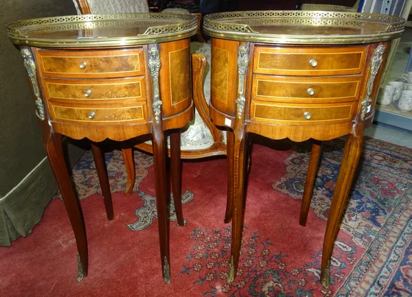 A pair of 20th century mahogany, walnut, gilt metal mounted three drawer oval occasional tables in the French style, 45cms wide (2). E3