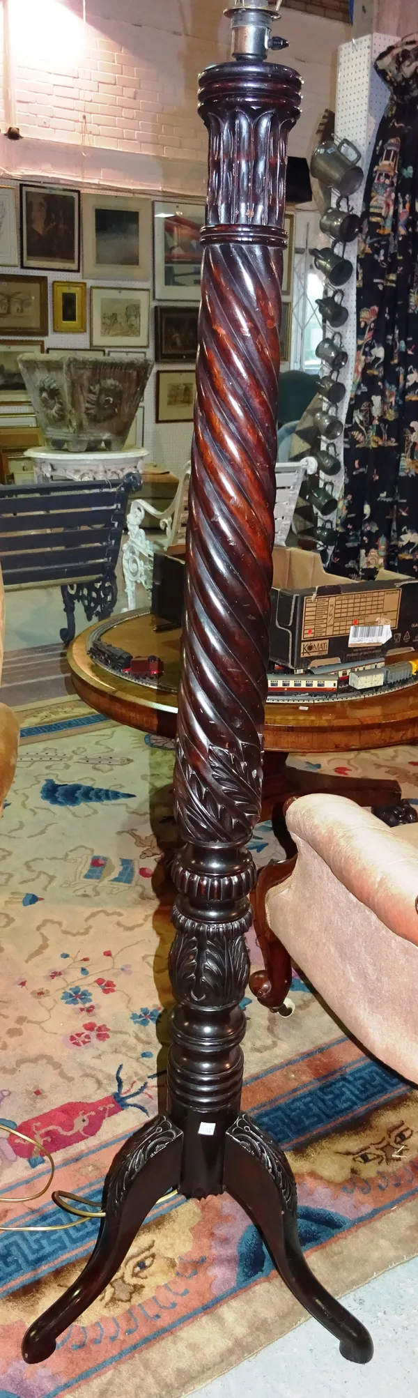 A mahogany standard lamp formed as a spiral reeded column, on slender baluster form. F5