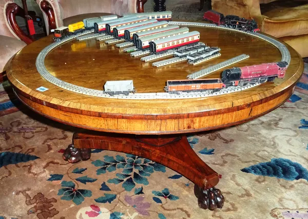 A William IV rosewood centre table, the circular top with a canted edge above a plain frieze, on a triform base on carved animal paw feet, reduced in