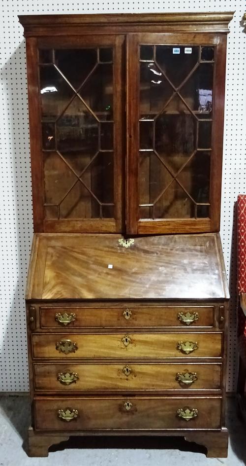 A George III and later mahogany bureau bookcase, the astragal glazed doors over fitted interior and four long graduated drawers, on bracket feet, 97cm