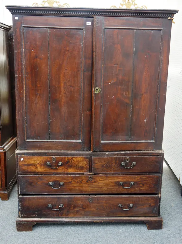 A mid-18th century elm linen press, with a pair of panelled doors over two short and two long drawers, on bracket feet, 130cm wide x 178cm high. M7