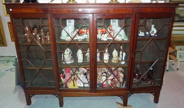 A George III style mahogany breakfront bookcase, with four astragal glazed doors, on low stand, 190cm wide x 135cm high. Rost