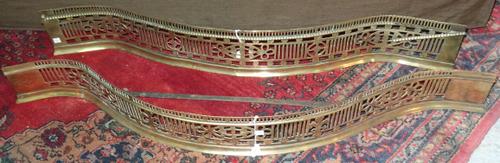 An early Victorian brass fire fender of pierced foliate serpentine form, 120cm wide, and another similar, (2). H3