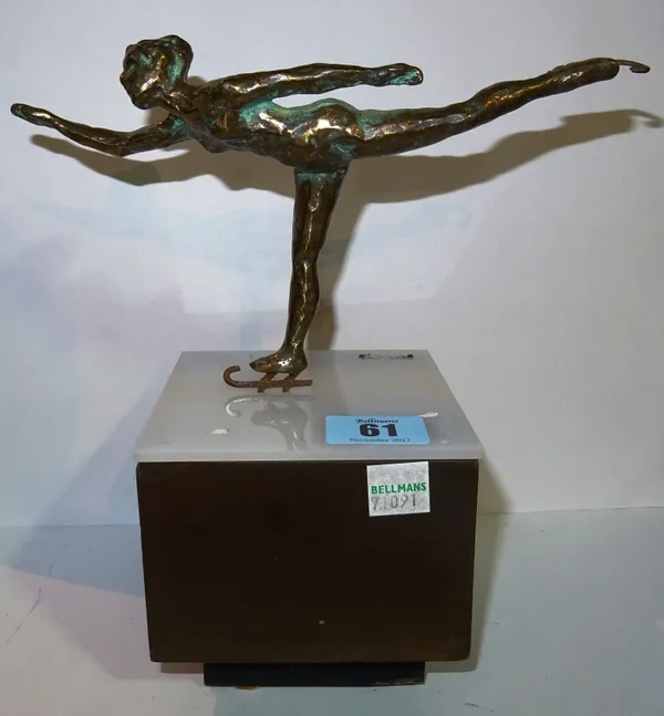 A Curtis Jere bronze skater, circa 1970, mounted on a perspex and wooden block, signed, 21cm high. CAB