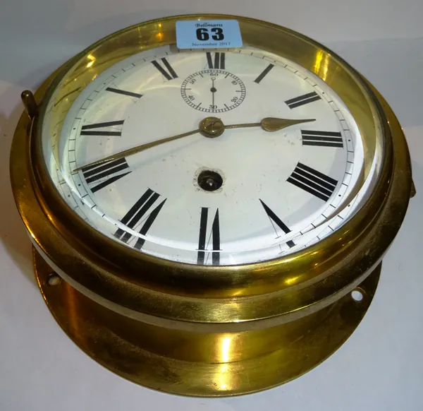 A brass ship's porthole wall clock, early 20th century, with five inch white enamel dial set with subsidiary seconds dial enclosing a single train mov