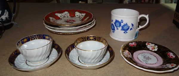 A group of English porcelain, first half 19th century, comprising; a Davenport cylindrical mug painted with blue leaves; a maroon ground plate reserve