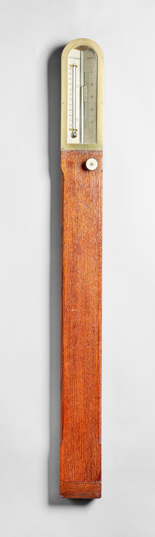 A late Victorian oak and brass-mounted Miner's or Pit-head stick barometerBy Negretti & Zambra, London, circa 1890The plain case with an arched pedime