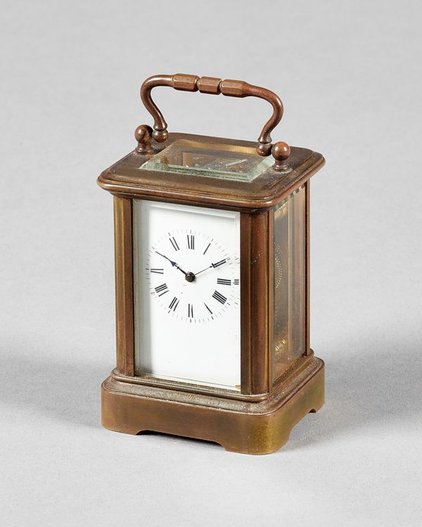 A French miniature brass carriage timepiece Circa 1890In a Corniche case, with bevelled glass panels, visible silvered platform lever escapement with