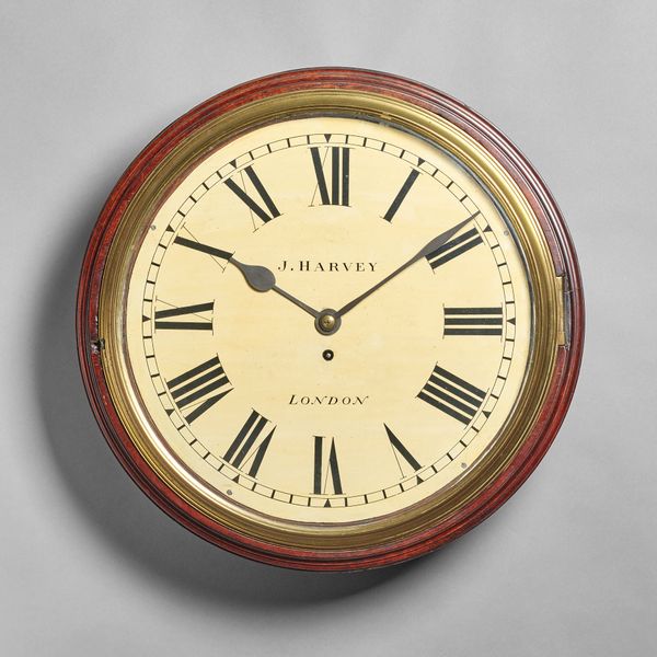 A late George III mahogany dial timepieceBy J. Harvey, London The rectangular case with shaped top and apron, with a turned surround and shaped cast b