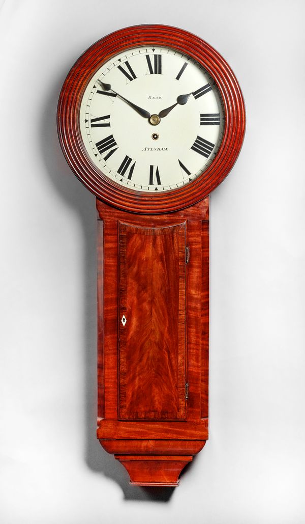 A Regency mahogany 'Norfolk' drop-dial wall timepieceBy Matthew Read, Aylsham, circa 1820The case with a circular glazed reeded dial surround, with oc