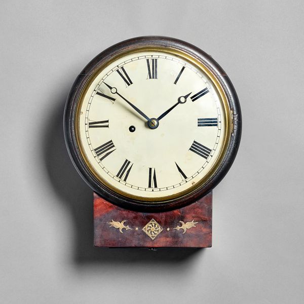 A Regency mahogany and brass-inlaid drop-dial timepieceThe cast bezel with convex glass above a white painted 8in. dial with Roman chapters and blued