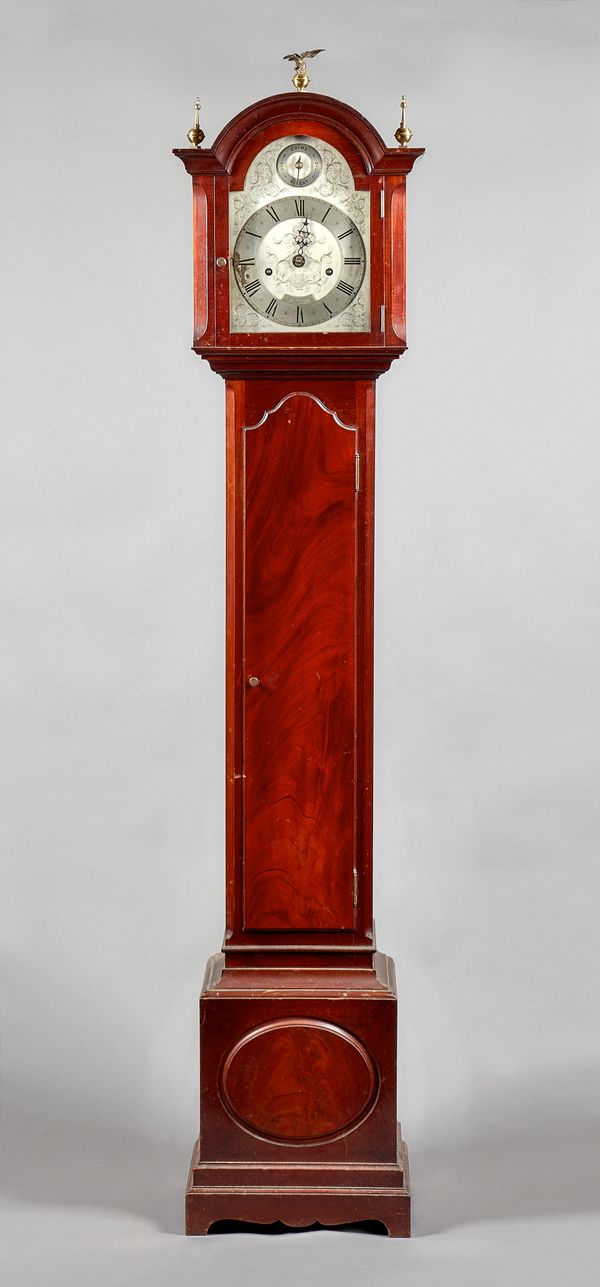 A mahogany quarter-chiming longcase clockof small size by Gillett & Johnston, Croydon, No. 15565, mid-20th centuryThe case, surmounted by three brass