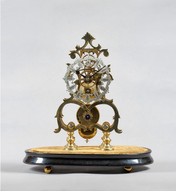 A brass skeleton timepieceCirca 1890The fusée movement with shaped plates and anchor escapement, on four baluster shaped feet, on an oval velvet-cover