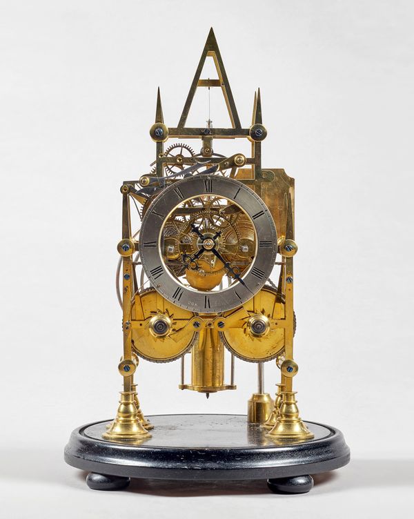A brass Gothic-style striking skeleton clockBy Cox, Islington, circa 1850With well pierced plates, six screwed tapering pillars, silvered chapter ring