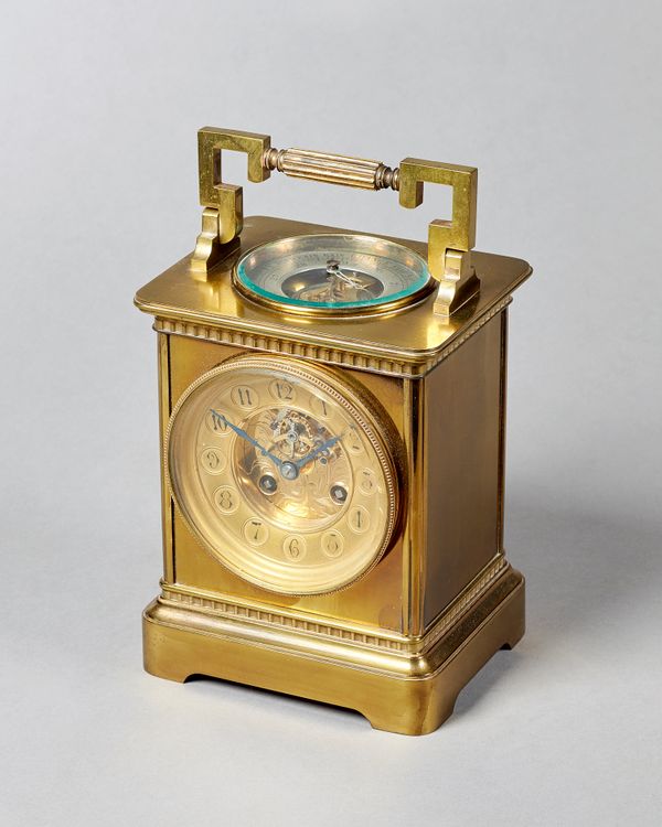 A French brass combination mantel clockCirca 1890In the form of an oversized carriage clock, the shaped handle above a circular inset glazed panel and