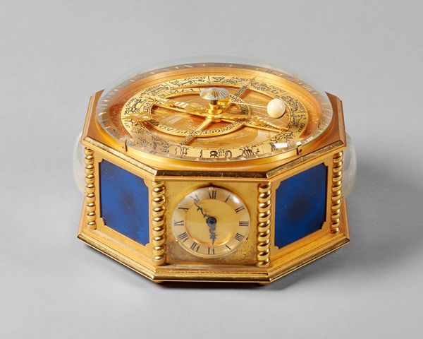 A French gilt, lacquered brass and blue enamel-mounted octagonal compendium table timepiece By Hour Lavigne, Paris, circa 1990The top with a convex gl
