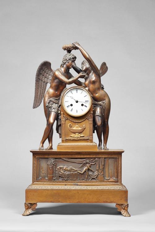 An Empire ormolu mantel clockBy L. Moinet, ParisThe case modelled with figures of Venus and Cupid, she holding a laurel wreath above his head; the arc