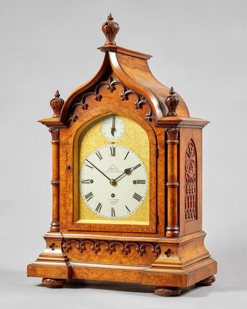 A late Victorian walnut Gothic Revival three train mantel clockBy Dent, London, No. 41210, circa 1890The arched case with three finials above a glazed