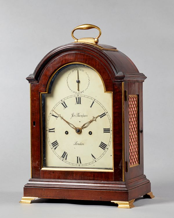 A George III mahogany and gilt brass-mounted bracket clockSigned Joseph Thompson, London, circa 1800The case with a broken arch pediment surmounted by