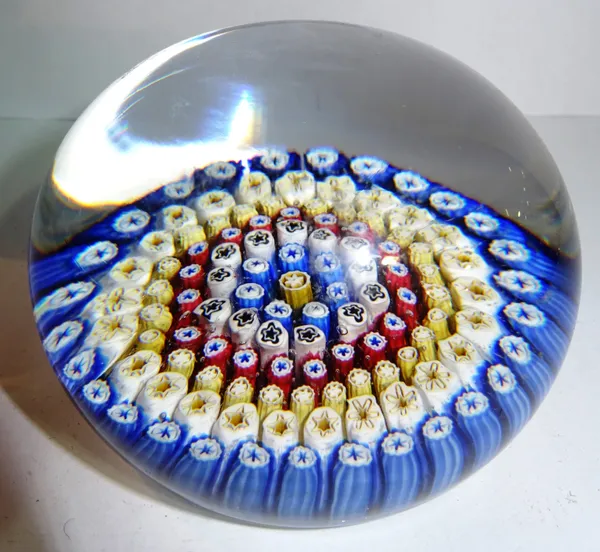 A French millefiori glass paperweight, circa 1900, with coloured cane in and stepped underside (7.5cm diameter). CAB