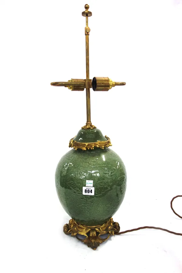 A Chinese celadon and ormolu table lamp, modern, with silk shade, 68cm high overall.