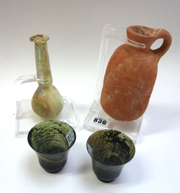 A Roman pottery oil jar, of upright spherical form, with a small loop handle, 13.5cm high, a Roman glass vase of ovoid form, with a tall thin neck, so