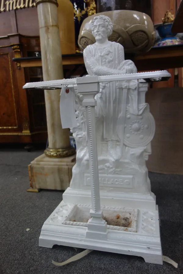 A white painted cast iron stick stand, titled 'WALLACE' with figural backplate and removable drip pan, 77.5cm high.