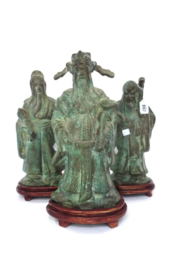 Three Chinese bronze figures, 20th century, variously modelled as Shoulao and scholars, each approximately 33cm. high, on wood stands (3). 13