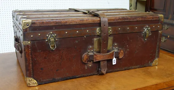 A French 'Moynat' leather and brass bound travel trunk, early 20th century with wooden slats to the lid and base, twin leather handles and strap, stam