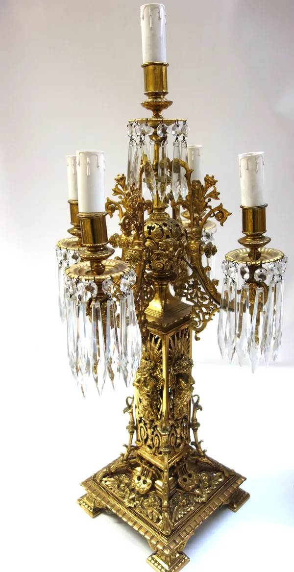 A pair of Victorian style brass five branch candelabra, 20th century, the foliate pierced frame adorned with angel figures, issuing five branches, eac