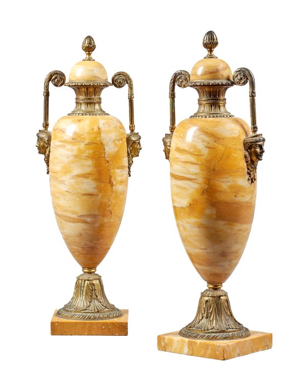 A pair of Italian Sienna marble and gilt metal mounted urns and covers, 19th century, each of twin handled form, with mask embellishments on a square