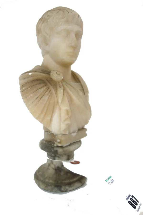 An alabaster bust carved of Julius Caesar raised on a socle (27cm high) and a terracotta head of a classical female figure on a later fluted wooden co