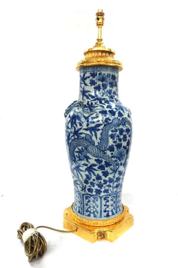 A Chinese porcelain and gilt brass mounted vase table lamp, 20th century, with applied dragons against a blue and white baluster body, 67cm high exclu
