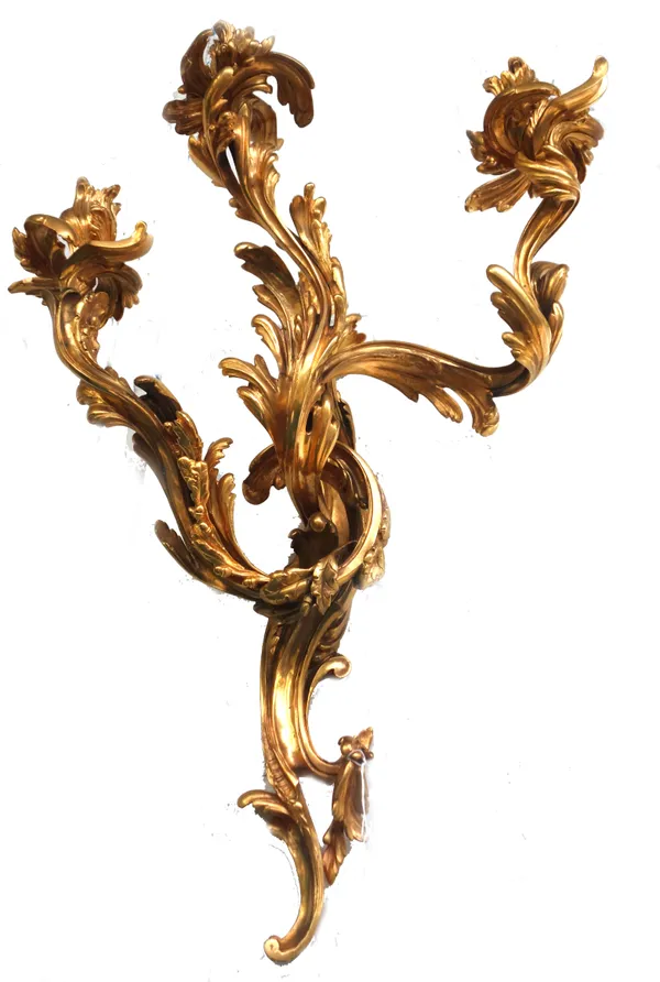 A pair of gilt bronze three branch wall appliques of Louis XV style, late 20th century, of foliate scroll form, 75cm high, (2).