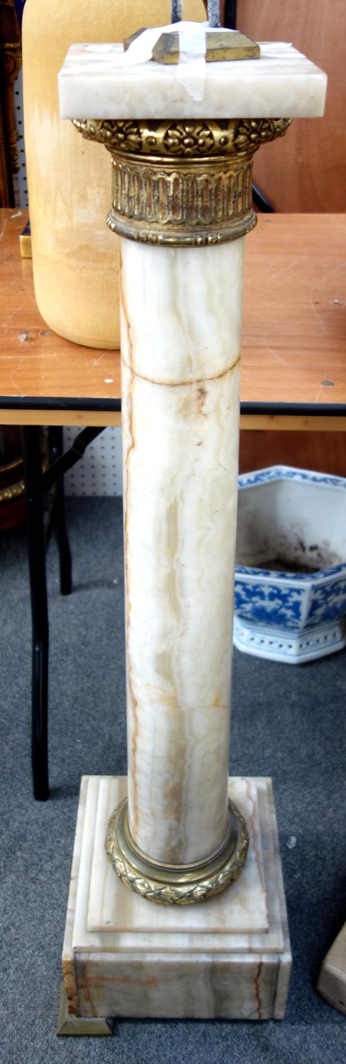 An onyx pedestal, late 19th century, with foliate cast ormolu mounts, square top, tapering circular column and a stepped square base (a.f), 110cm high