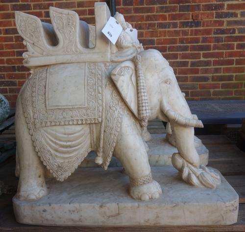 A pair of Indian marble models of elephants, 20th century, each carved with foliate howdah and turbaned rider, on a rounded rectangular base, 70cm hig