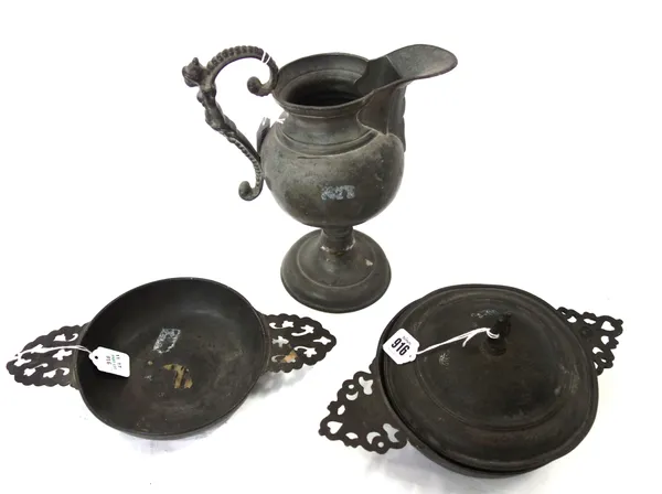 An English pewter two handled porringer and cover, 18th century, with dolphin finial to the circular cover, indistinct touch marks, 29cm across the ha