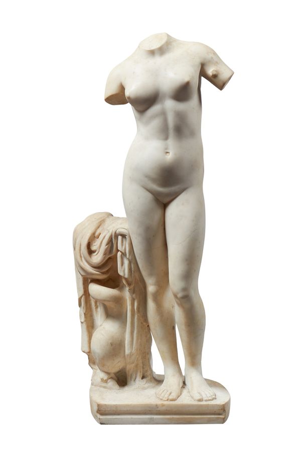A marble figure of the Venus of Cyrene, after the Antique, modelled standing with a dolphin at her side, on a shaped base, unsigned. 75cm high.  Illus