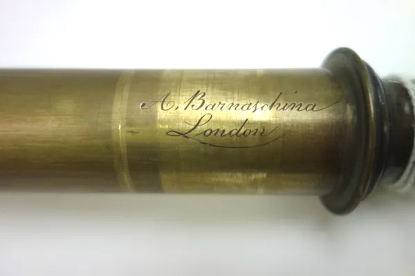 An early 19th century brass and wooden bound single drawer telescope, signed 'A. Barnaschina, London', the painted wooden sleeve of faceted form, 82cm