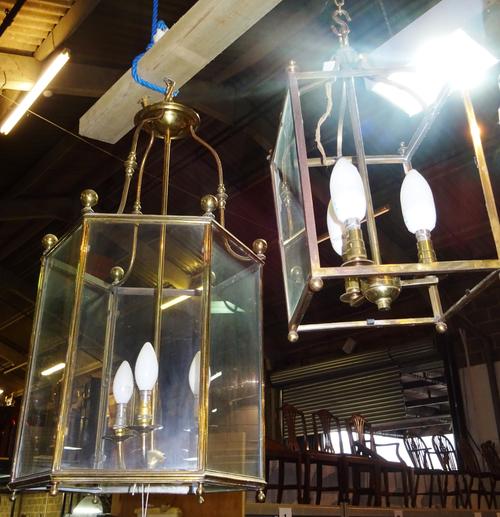 A large 20th century hexagonal brass and glass hall lantern and a pair of similar smaller square glass lanterns, (3). Hang