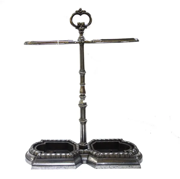 An Edwardian style polished steel twin division stick stand, with foliate loop handle over a tapering hexagonal shaft, with two removable drip trays,