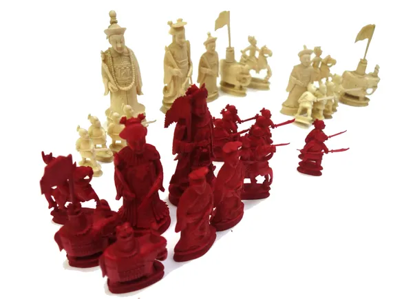 A Chinese export stained ivory chess set, early 20th century, each modelled as an Oriental figure, the warrior pawns holding long arm blades, (a.f), (