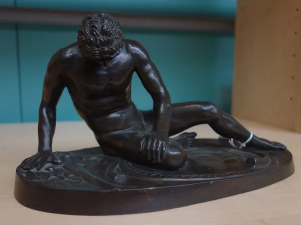 After the Antique; a French patinated bronze figure of 'The Dying Gaul', late 19th century, on an oval relief cast base, unsigned, 28.5cm wide.