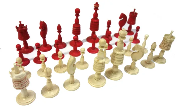 An English stained ivory chess set, 19th century, the Kings and Queens of turned tapering form, (King 10cm high) and a Staunton stained wood chess set