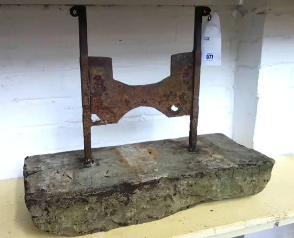 A Victorian cast iron boot scraper, the square bar up-rights united by a recessed flat foot plate on a rectangular stone plinth, 58cm wide.