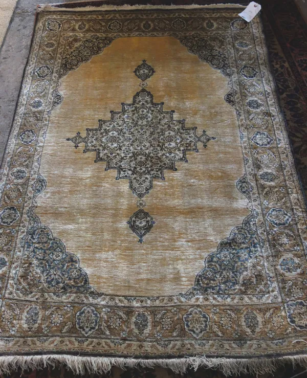 A Ghom silk rug, Persian the plain gold field with a stepped medallion, matching spandrels, a palmette border, 150 x 105cm.