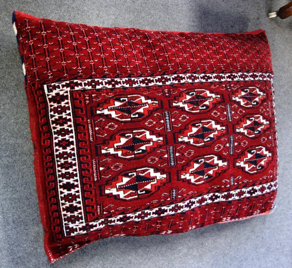 A pair of Tekke Turkman saddle bags, with three rows of three guls, on a madder ground, used as floor cushions, each 104cm x 76cm, (2).