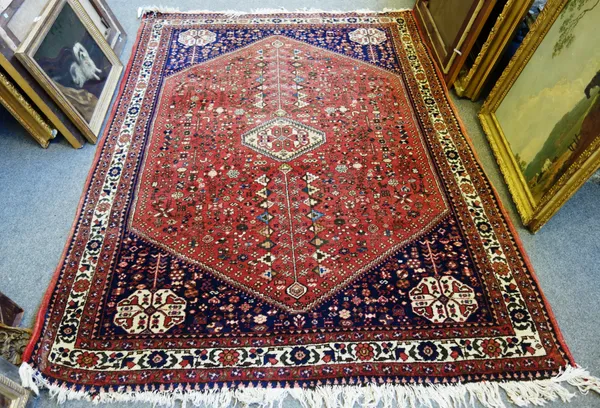 A Quasghai rug, South Persian, the madder field with an ivory medallion, four similar corner motifs, all with floral motifs, an ivory border, 210cm x