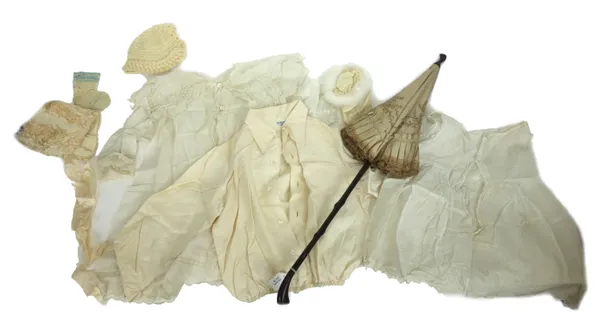 A collection of early 20th century baby's clothes, bonnets, petticoats and pillow cases, and a parasol, (qty).