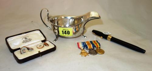 A 1934 silver sauceboat by Edward Viner, a pair of rose gold coloured cufflinks and miniature dress medals.  CAB